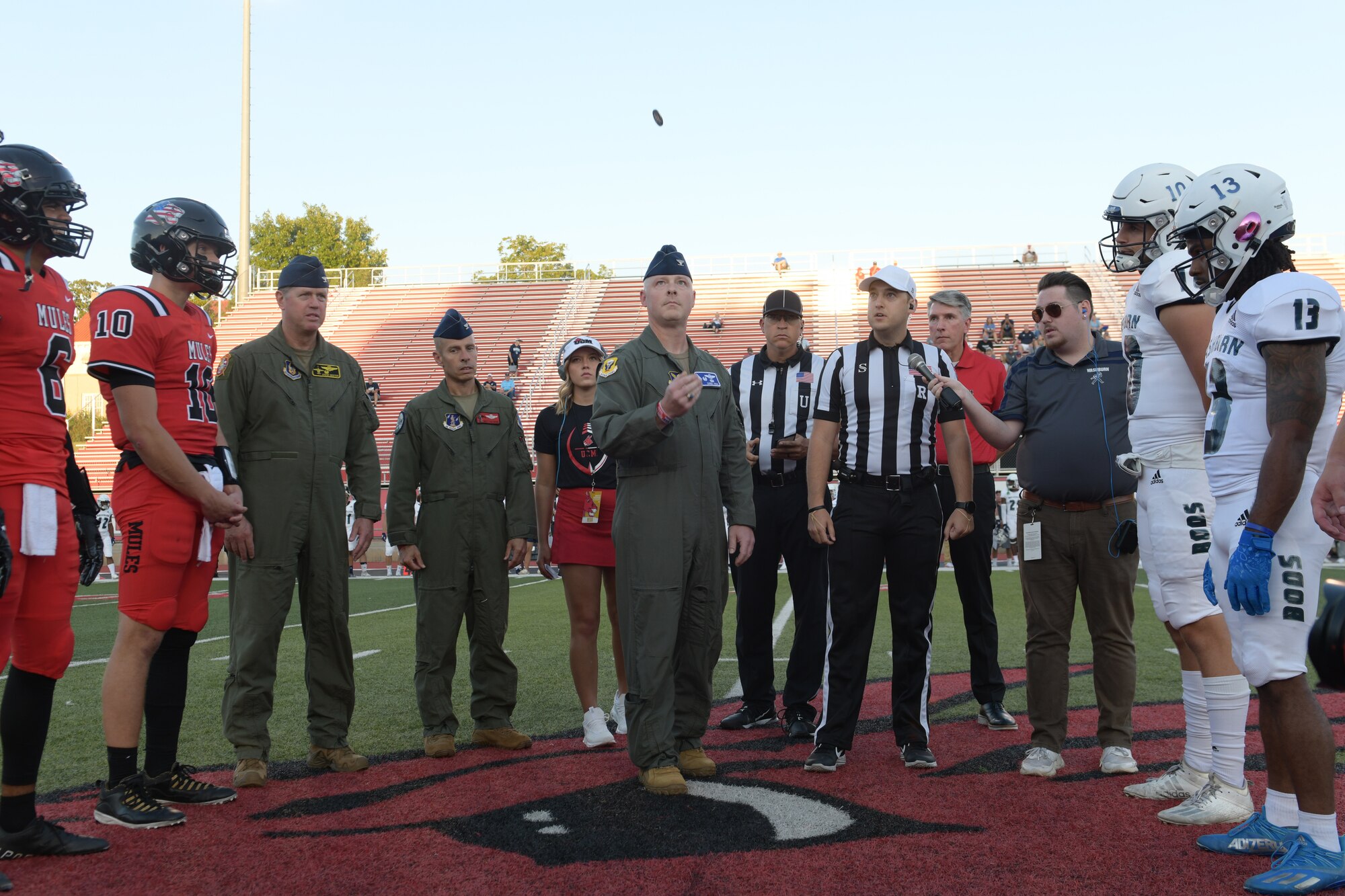 U.S. Air Force Col. Daniel Diehl, 509th Bomb Wing Commander, performs the coin toss prior to the University of Central Missouri Military Appreciation football game, Sept. 8, 2022, in Warrensburg, Missouri. Whiteman AFB and UCM share a valuable community partnership that fosters a supportive relationship between the base and local communities. (U.S. Air Force photo by Tech. Sgt. Dylan Nuckolls)