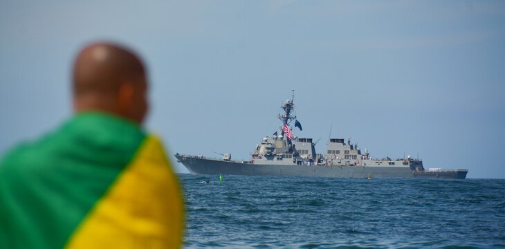 A man watches the Arleigh Burke-class guided-missile destroyer USS Lassen (DDG 82) pass during the Parade of Ships marking Brazil’s bicentennial during UNITAS LXIII, Sept. 7, 2022.