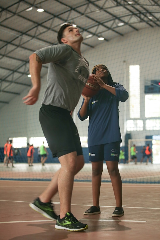 RIO DE JANEIRO (Sept. 12, 2022) U.S. Marine Corps Sgt. Kellen Wonder plays basketball with local children during a community relations event during UNITAS LXIII, Sept. 12, 2022. UNITAS is the world’s longest-running maritime exercise. Hosted this year by Brazil, it brings together multinational forces from Belize, Brazil, Cameroon, Chile, Colombia, Dominican Republic, Ecuador, France, Guyana, Jamaica, Mexico, Namibia, Panama, Paraguay, Peru, South Korea, Spain, United Kingdom, Uruguay, and the United States conducting operations in and off the coast of Rio de Janeiro. The exercise trains forces to conduct joint maritime operations through the execution of anti-surface, anti-submarine, anti-air, amphibious and electronic warfare operations that enhance warfighting proficiency and increase interoperability among participating naval and marine forces. (U.S. Marine Corps photo by Cpl. Ethan Craw/Released)