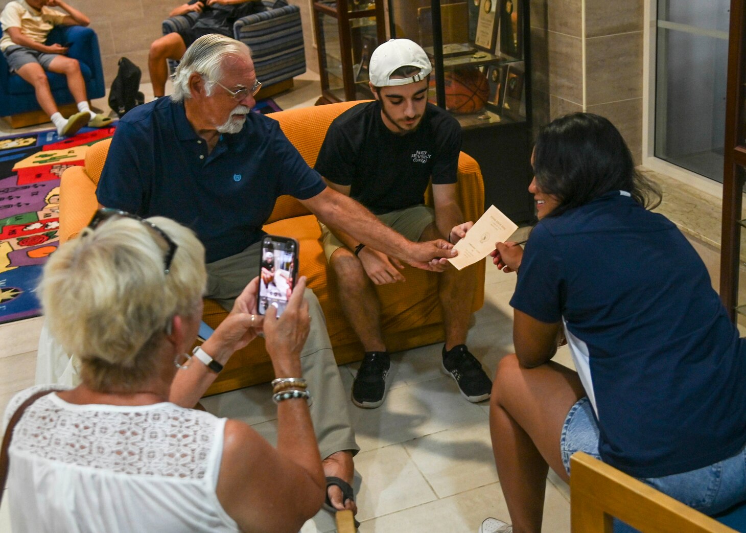 220818-N-UJ449-1006 NAVAL AIR STATION SIGONELLA, Italy (Aug. 18, 2022) Former Naval Air Station Sigonella high school graduate retired U.S. Navy Reservist Richard Kaiser, visits and talks with current high school class presidents on NAS Sigonella, Aug. 18, 2022. NAS Sigonella’s strategic location enables U.S., allied, and partner nation forces to deploy and respond as required, ensuring security and stability in Europe, Africa and Central Command. (U.S. Navy photo by Mass Communication Specialist 1st Class Josh Coté)