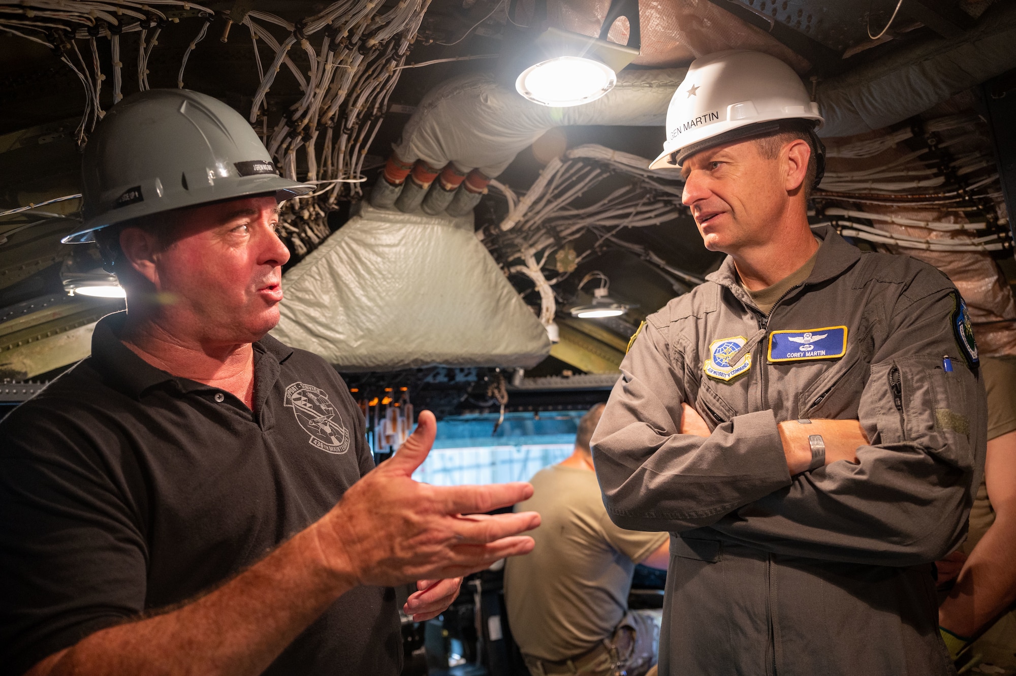 Maj. Gen. Corey Martin, 18th Air Force commander, right, speaks with John Greim, C-5 Isochronal Inspection Dock coordinator, during his visit to Dover Air Force Base, Delaware, Sept. 13, 2022. Martin experienced Dover’s unique mission by touring the C-5 ISO Dock, 436th Aerial Port Squadron and 436th Logistics Readiness Squadron. (U.S. Air Force photo by Senior Airman Cydney Lee)