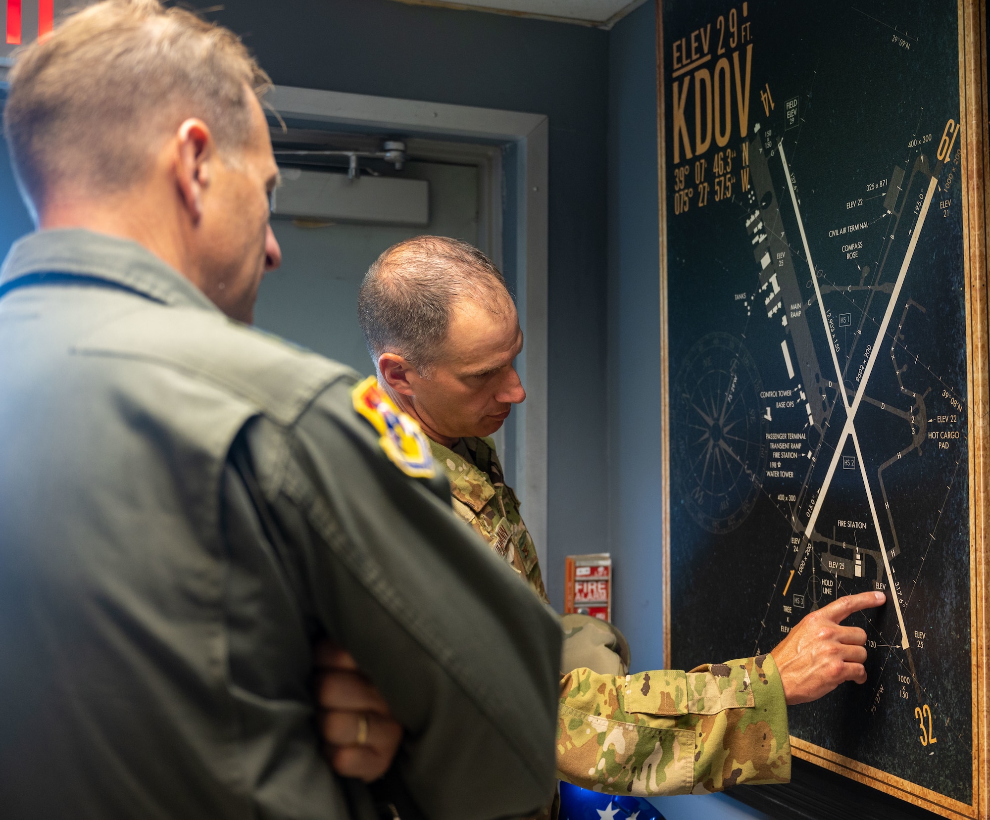 Col. Matt Husemann, 436th Airlift Wing commander, right, discusses a map of Dover Air Force Base with Maj. Gen. Corey Martin, 18th Air Force commander, during his visit to Dover AFB, Delaware, Sept. 13, 2022. Martin experienced Dover’s unique mission by touring the C-5 Isochronal Inspection Dock, 436th Aerial Port Squadron and 436th Logistics Readiness Squadron. (U.S. Air Force photo by Senior Airman Cydney Lee)
