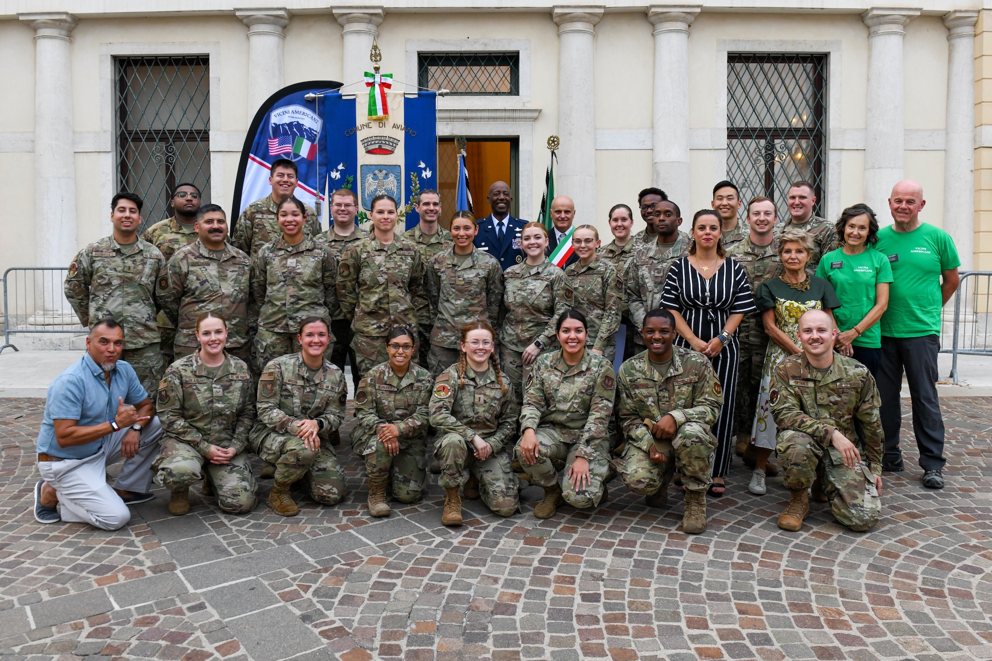 U.S. Air Force Airmen from Aviano Air Base and other members of the Wyvern community pose for a photo at a recognition ceremony in Aviano, Italy, Sept. 13, 2022. Daniele Basso, the vice mayor of Aviano, Mario Della Toffola, Polcenigo mayor, and U.S. Air Force Col. Timothy Maxwell, 31st Mission Support Group commander, recognized more than 30 members that volunteered or helped coordinate for the local school visits and the summer camps. (U.S. Air Force photo by Senior Airman Thomas S. Keisler IV)