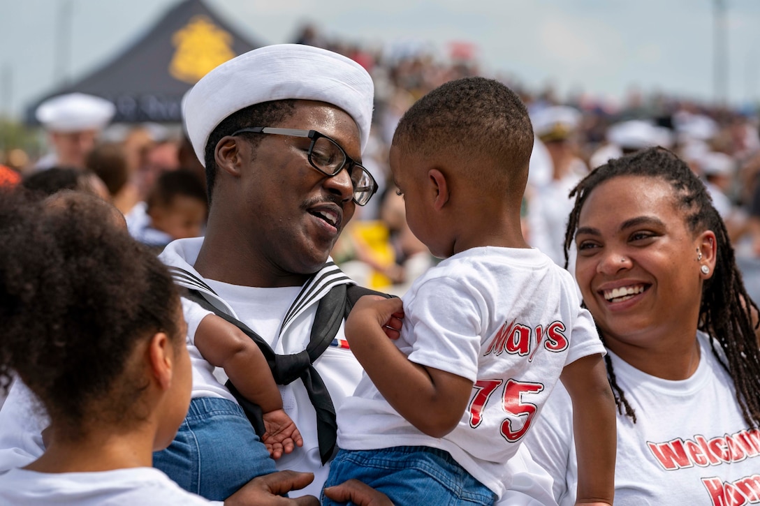 A sailor reunites with his family.