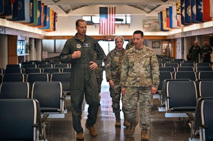 A group of airmen walk down airport terminal