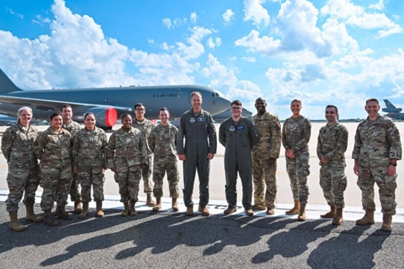 Group of airmen stand for a photo on flightline