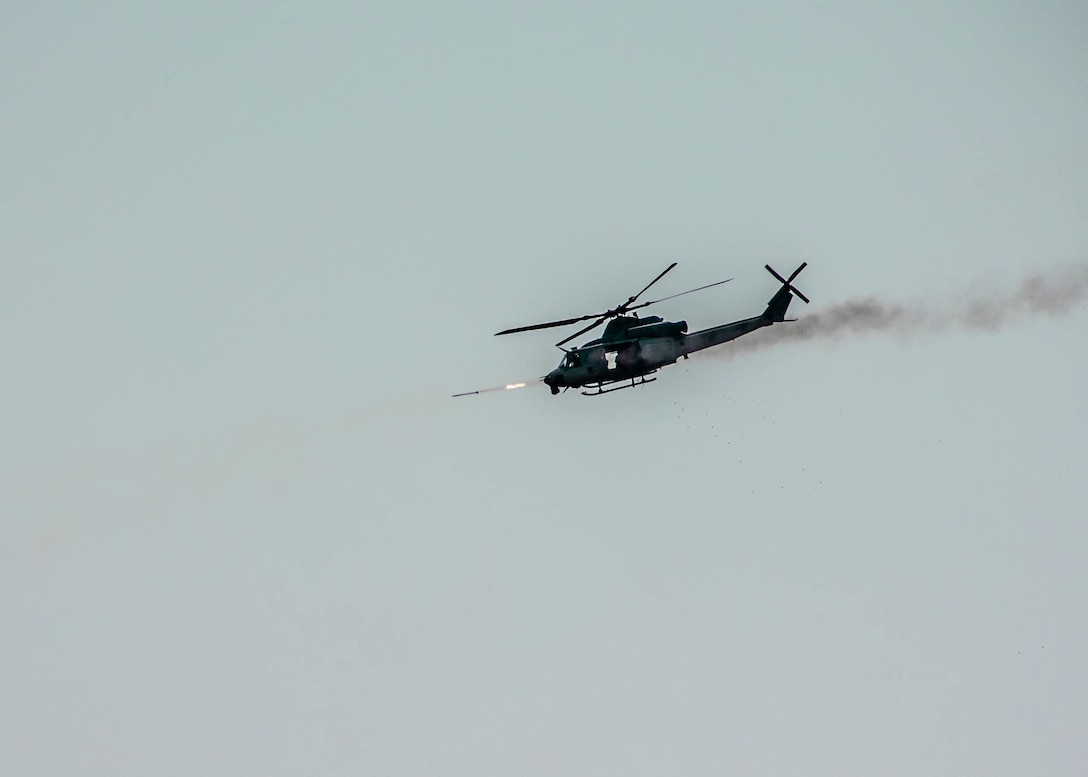 A UH-1Y Venom helicopter, attached to Marine Light Attack Helicopter Squadron (HMLA) 773, 4th Marine Aircraft Wing, Marine Forces Reserve, in support of Special Purpose Marine Air-Ground Task Force UNITAS LXIII, fires a rocket during close air support drills as part of exercise UNITAS LXIII at Santa Cruz Air Force Base, Rio de Janeiro, Sept. 8, 2022. HMLA 773 and 4th Air Naval Gunfire Liaison Company cross trained with the Brazilian Marine Corps by conducting close air support drills, which consists of locating targets from the ground and relaying coordinates to assets in the sky to destroy. UNITAS trains forces to conduct joint maritime operations through the execution of anti-surface, anti-submarine, anti-air, amphibious and electronic warfare operations that enhance warfighting proficiency and increase interoperability among participating naval and marine forces. (U.S. Marine Corps photo by Cpl. Colton K. Garrett)