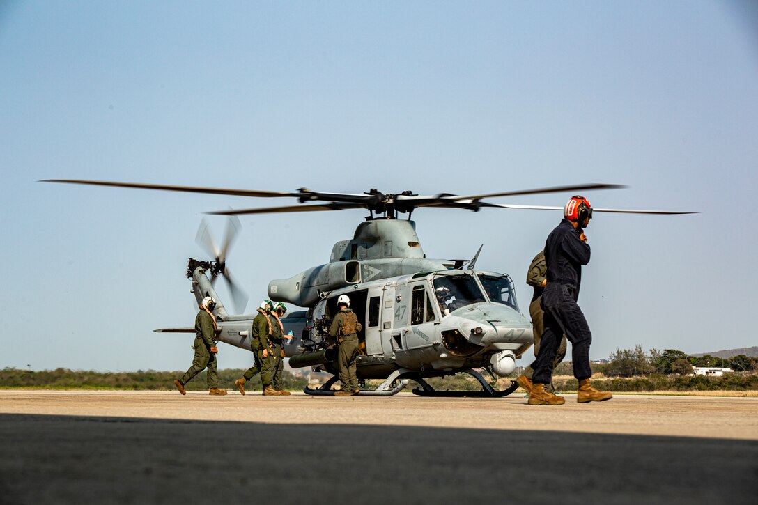 U.S. Marine maintainers with Marine Light Attack Helicopter Squadron (HMLA) 773, 4th Marine Aircraft Wing, Marine Forces Reserve, in support of Special Purpose Marine Air-Ground Task Force UNITAS LXIII, board a UH-1Y Venom at São Pedro da Aldeia, Brazil, during exercise UNITAS LXIII, Sept. 8, 2022. UNITAS is the world's longest-running annual multinational maritime exercise that focuses on enhancing interoperability among multiple nations and joint forces during littoral and amphibious operations in order to build on existing regional partnerships and create new enduring relationships that promote peace, stability and prosperity in the U.S. Southern Command’s area of responsibility. (U.S. Marine Corps photo by 1st Lt. Mark L. Andries)