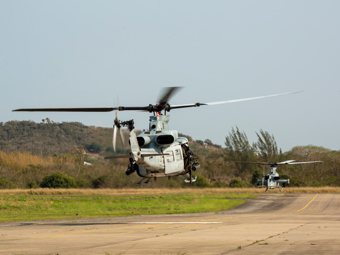 An AH-1Z Viper and a UH-1Y Venom with Marine Light Attack Helicopter Squadron (HMLA) 773, 4th Marine Aircraft Wing, Marine Forces Reserve, in support of Special Purpose Marine Air-Ground Task Force UNITAS LXIII, taxi to the runway to conduct flight operations at São Pedro da Aldeia, Brazil, during exercise UNITAS LXIII, Sept. 4, 2022. UNITAS is the world's longest-running annual multinational maritime exercise that focuses on enhancing interoperability among multiple nations and joint forces during littoral and amphibious operations in order to build on existing regional partnerships and create new enduring relationships that promote peace, stability and prosperity in the U.S. Southern Command’s area of responsibility. (U.S. Marine Corps photo by 1st Lt. Mark L. Andries)