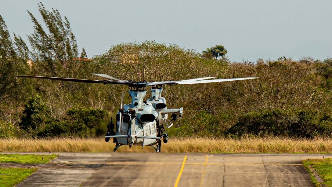 An AH-1Z Viper and a UH-1Y Venom with Marine Light Attack Helicopter Squadron (HMLA) 773, 4th Marine Aircraft Wing, Marine Forces Reserve, in support of Special Purpose Marine Air-Ground Task Force UNITAS LXIII, taxi to the runway to conduct flight operations at São Pedro da Aldeia, Brazil, during exercise UNITAS LXIII, Sept. 4, 2022. UNITAS is the world's longest-running annual multinational maritime exercise that focuses on enhancing interoperability among multiple nations and joint forces during littoral and amphibious operations in order to build on existing regional partnerships and create new enduring relationships that promote peace, stability and prosperity in the U.S. Southern Command’s area of responsibility. (U.S. Marine Corps photo by 1st Lt. Mark L. Andries)