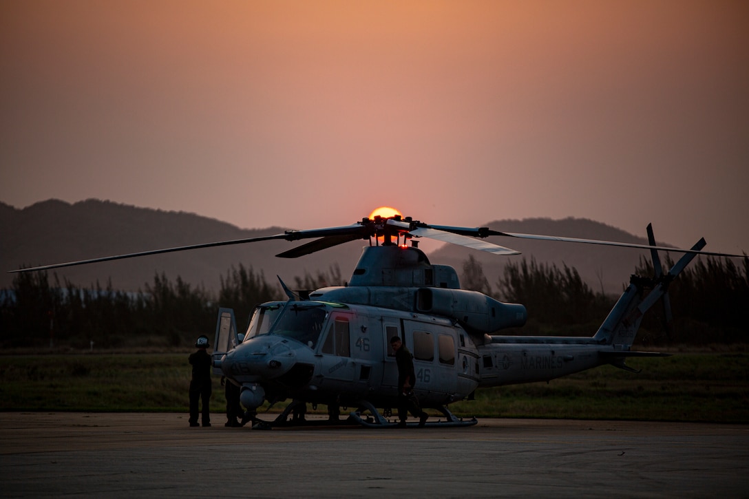 U.S. Marines with Marine Light Attack Helicopter Squadron - 773, 4th Marine Aircraft Wing, Marine Forces Reserve, in support of Special Purpose Marine Air-Ground Task Force UNITAS LXIII, conduct preventative maintenance on a UH-1Y Venom at São Pedro da Aldeia, Brazil, during exercise UNITAS LXIII, Sept. 8, 2022. UNITAS is the world's longest-running annual multinational maritime exercise that focuses on enhancing interoperability among multiple nations and joint forces during littoral and amphibious operations in order to build on existing regional partnerships and create new enduring relationships that promote peace, stability and prosperity in the U.S. Southern Command’s area of responsibility. (U.S. Marine Corps photo by 1st Lt. Mark L. Andries)