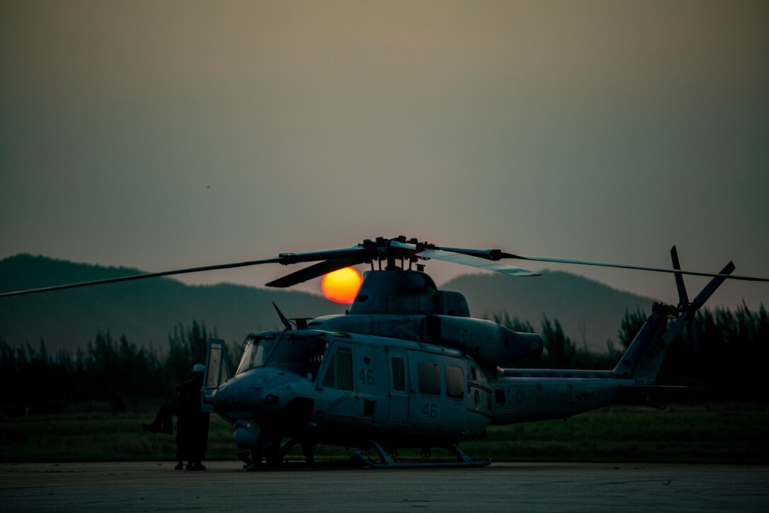 U.S. Marines with Marine Light Attack Helicopter Squadron - 773, 4th Marine Aircraft Wing, Marine Forces Reserve, in support of Special Purpose Marine Air-Ground Task Force UNITAS LXIII, conduct preventative maintenance on a UH-1Y Venom at São Pedro da Aldeia, Brazil, during exercise UNITAS LXIII, Sept. 8, 2022. UNITAS is the world's longest-running annual multinational maritime exercise that focuses on enhancing interoperability among multiple nations and joint forces during littoral and amphibious operations in order to build on existing regional partnerships and create new enduring relationships that promote peace, stability and prosperity in the U.S. Southern Command’s area of responsibility. (U.S. Marine Corps photo by 1st Lt. Mark L. Andries)