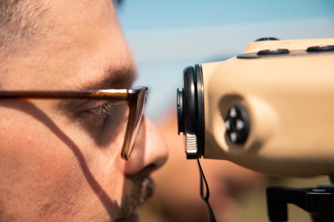 U.S. Marine Corps Lance Cpl. Robert Furton, a forward observer with 4th Air Naval Gunfire Liaison Company, Marine Force Reserve, in support of Special Purpose Marine Air-Ground Task Force UNITAS LXIII, looks through a common laser range finder during close air support drills as part of exercise UNITAS LXIII at Santa Cruz Air Force Base, Rio de Janeiro, Sept. 8, 2022. Light Attack Helicopter Squadron (HMLA) 773 and 4th ANGLICO cross trained with the Brazilian Marine Corps by conducting close air support drills, which consists of locating targets from the ground and relaying coordinates to assets in the sky to destroy. UNITAS trains forces to conduct joint maritime operations through the execution of anti-surface, anti-submarine, anti-air, amphibious and electronic warfare operations that enhance warfighting proficiency and increase interoperability among participating naval and marine forces. (U.S. Marine Corps photo by Cpl. Colton K. Garrett)