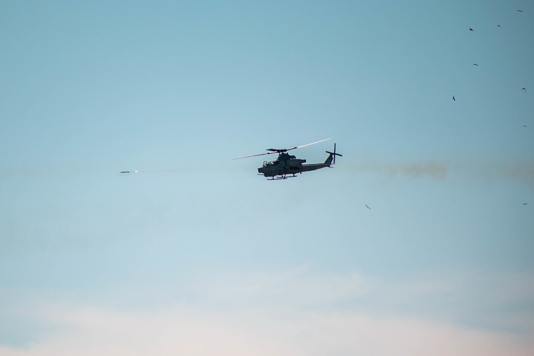 A U.S. Marine Corps AH-1Z Viper helicopter assigned to Light Attack Helicopter Squadron (HMLA) 773, 4th Marine Aircraft Wing, Marine Forces Reserve, in support of Special Purpose Marine Air-Ground Task Force UNITAS LXIII, fires a rocket during close air support drills as part of exercise UNITAS LXIII at Santa Cruz Air Force Base, Rio de Janeiro, Sept. 8, 2022. HMLA 773 and 4th Air Naval Gunfire Liaison Company cross trained with the Brazilian Marine Corps by conducting close air support drills, which consists of locating targets from the ground and relaying coordinates to assets in the sky to destroy. UNITAS trains forces to conduct joint maritime operations through the execution of anti-surface, anti-submarine, anti-air, amphibious and electronic warfare operations that enhance warfighting proficiency and increase interoperability among participating naval and marine forces. (U.S. Marine Corps photo by Cpl. Colton K. Garrett)