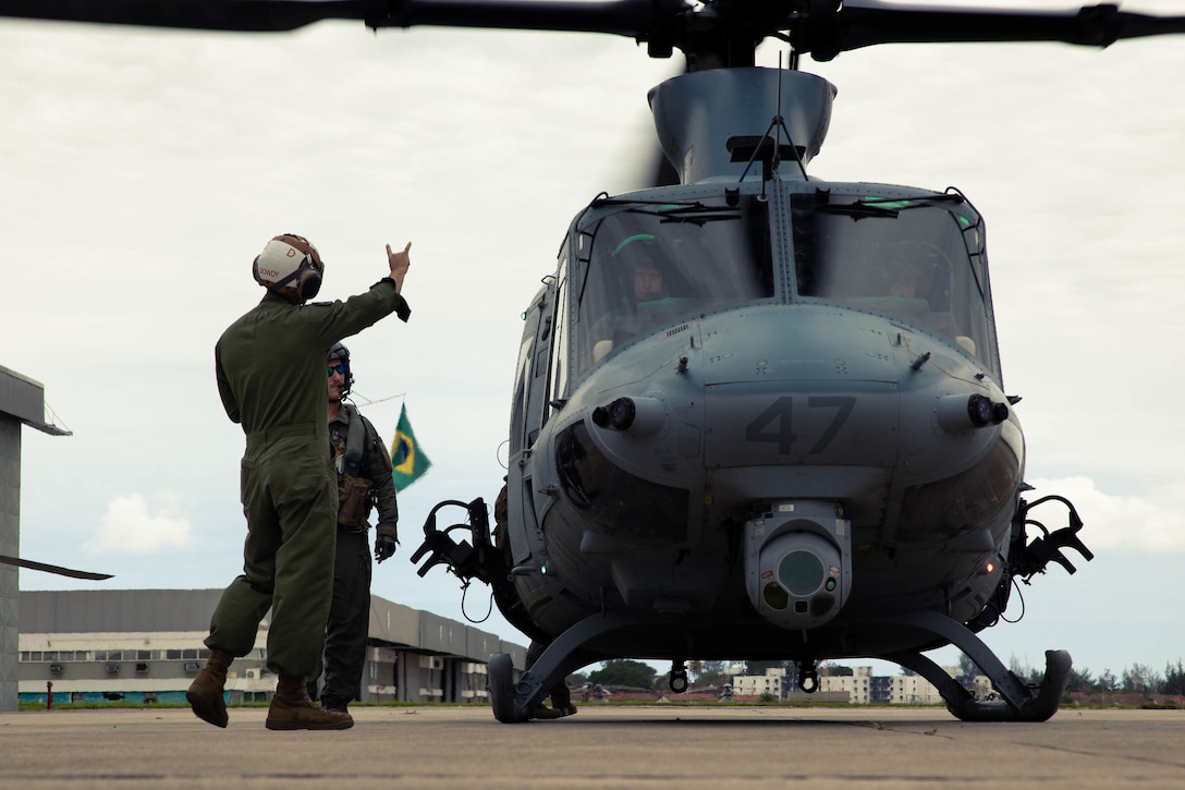 U.S. Marines with Marine Light Attack Helicopter Squadron (HMLA) 773, 4th Marine Aircraft Wing, Marine Forces Reserve, in support of Special Purpose Marine Air-Ground Task Force UNITAS LXIII, conduct preflight procedures on a UH-1Y Venom helicopter at São Pedro da Aldeia, Brazil, Sept. 5, 2022. HMLA 773 and 4th Air Naval Gunfire Liaison Company cross trained with the Brazilian Marine Corps by conducting simulated close air support drills, which consists of locating targets from the ground and relaying coordinates to assets in the sky to destroy. UNITAS trains forces to conduct joint maritime operations through the execution of anti-surface, anti-submarine, anti-air, amphibious and electronic warfare operations that enhance warfighting proficiency and increase interoperability among participating naval and marine forces. (U.S. Marine Corps photo by Cpl. Colton K. Garrett)
