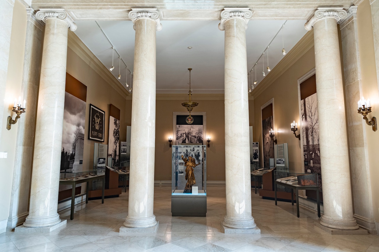 Four columns mark the entrance to a room filled with display cases and memorabilia