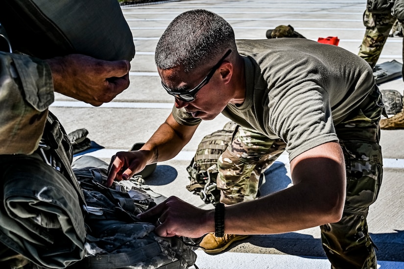 A U.S. Army Soldier assigned to the 404th Civil Affairs Battalion, prepares a jump pack for an Airborne operation at Joint Base McGuire-Dix-Lakehurst, N.J. on Sept. 10, 2022. The unit conducted non-tactical airborne operations at the Army Aviation Facility in order to maintain mission readiness and proficiency among their paratroopers with the assistance of two CH-47’s out of Virginia.The Army Aviation Facility was created through a MILCON effort valued at 11.7 million dollars and made possible by the joint effort of ASA Fort Dix and the U.S. Marine Corps Marine Aircraft Group 49. The 2100 square foot building is host to an Army Ramp Management Area which provides a wide range of capabilities for both fixed and rotary wing aircraft such as the C-130, CH-47S, and UH-60S.