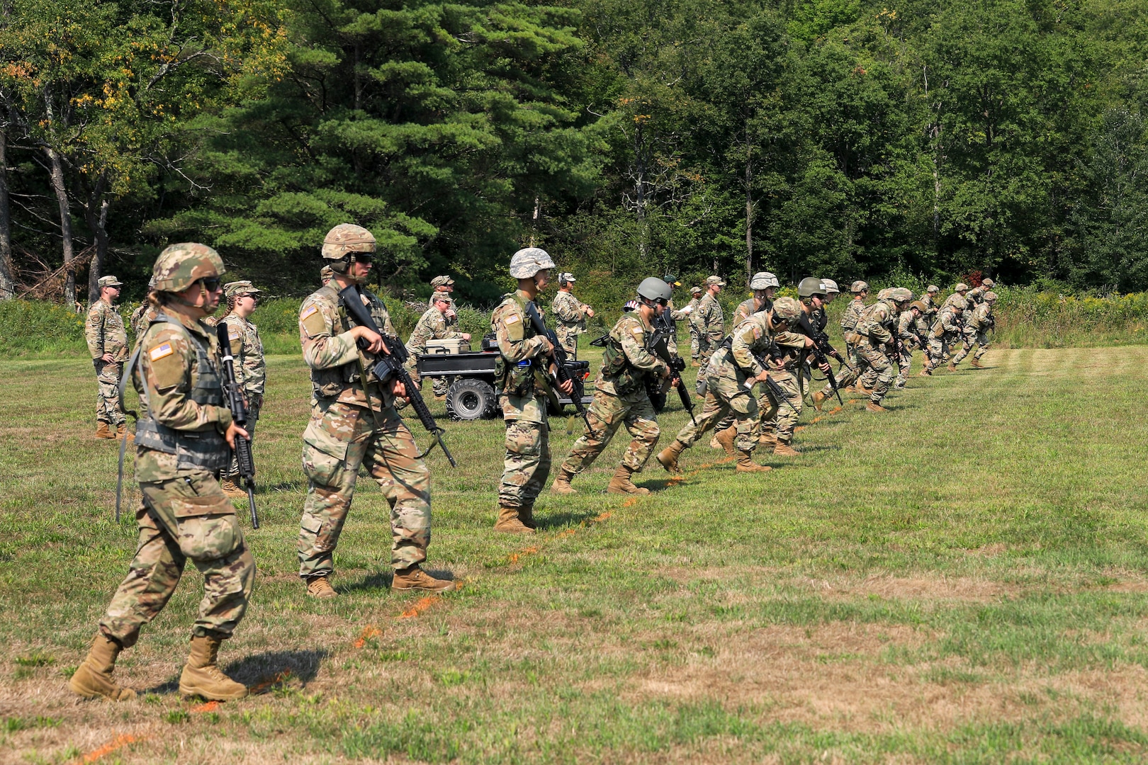 Vermont Army National Guard Soldiers and Airmen begin running towards the firing line during the 2022 Adjutant General's Combat Marksmenship Competition. The competitors must sprint 100 yards to the firing line to elevate their heart rates before firing at a 12 inch target from 200 yards. (U.S. Army National Guard photo by Sgt. 1st Class Jason Alvarez)