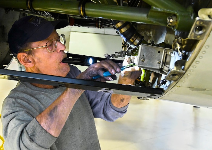 Randy Kemp works in one of the engine cowlings of the Champaign Gal, a World War II-era B-25 bomber, on Feb. 12, 2022, at the Champaign Aviation Museum in Urbana, Ohio. Kemp oversees maintenance on the 78-year-old plane to keep it airworthy. (U.S. Air Force photo by R.J. Oriez)