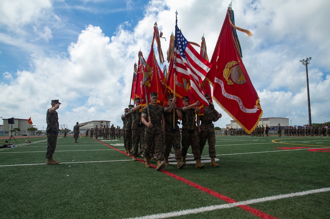 U.S. Marines with 3d Marine Division pass in review during a battle colors rededication ceremony rehearsal on Camp Hansen, Okinawa, Japan, Sept. 13, 2022.