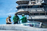 Sailors work aboard ship.