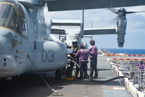 Sailors refuel an aircraft.