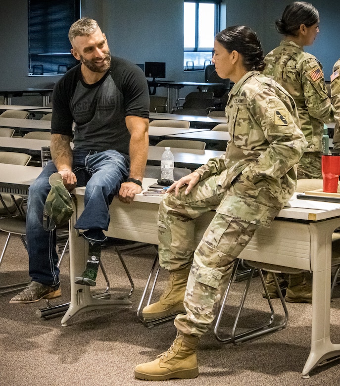 Earl Granville, a former U.S. Army sergeant, speaks with Sgt. Maj. Suzanne Polk, 75th Innovation Command G-1 sergeant major, following Granville's presentation about resilience at the 75th Innovation Headquarters in Houston.