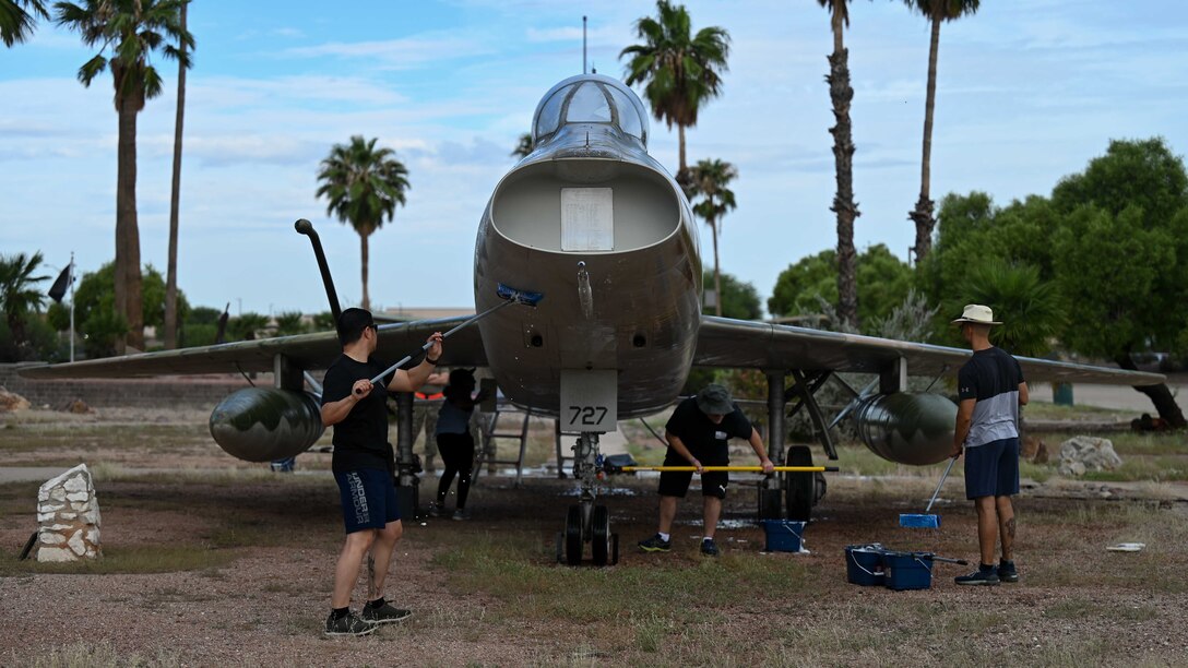 A photo of people washing a plane.