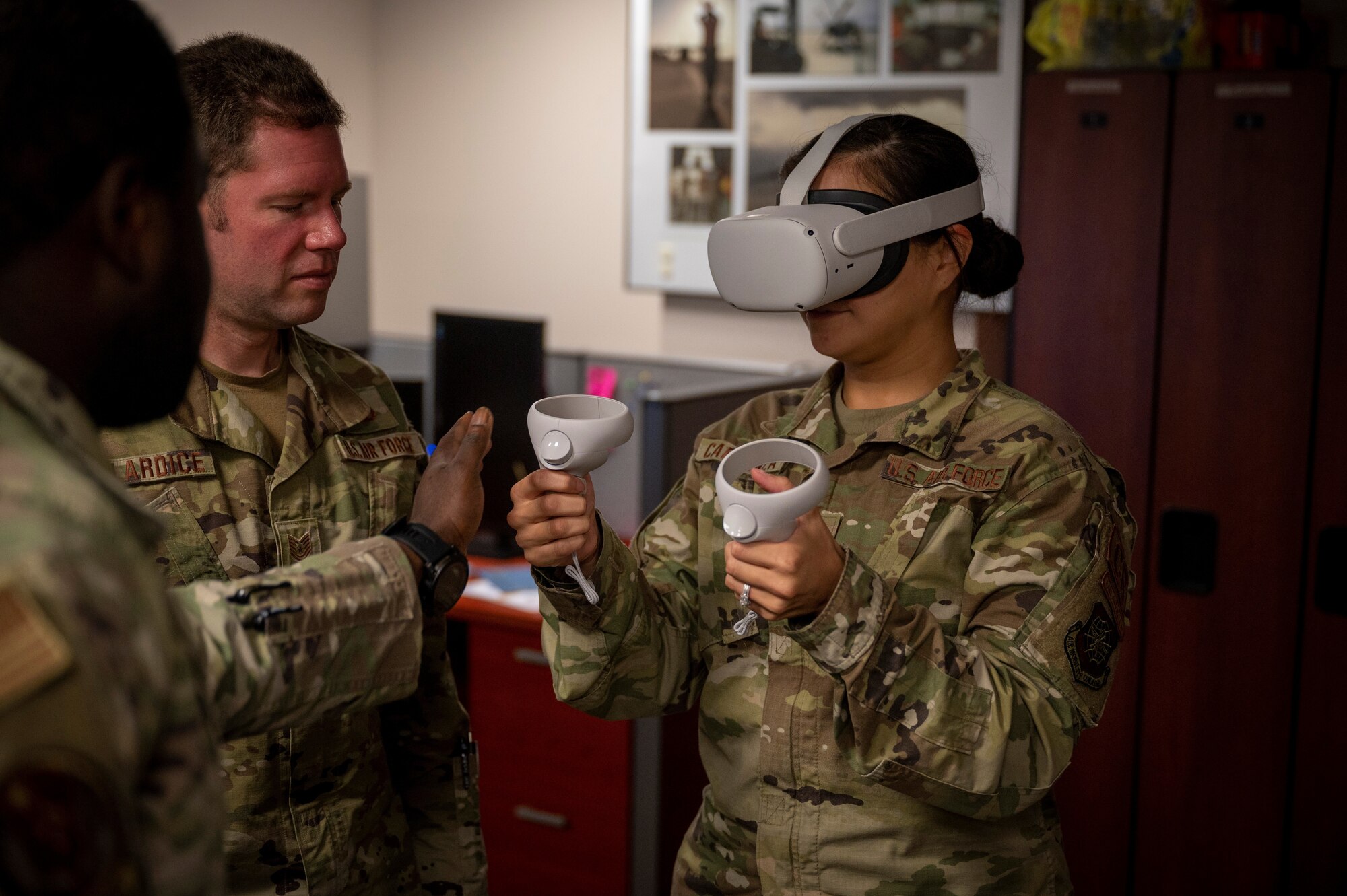 U.S. Air Force Tech. Sgt. Sylvia Carranza, 818th Mobility Support Advisory Squadron air advisor, wears a virtual reality headset and hand controllers Sept. 08, 2022, at Joint Base McGuire-Dix-Lakehurst, New Jersey. Air advisors are using virtual reality to enhance their French language program and advisory role capabilities. (U.S. Air Force photo by Tech. Sgt. Luther Mitchell Jr.)