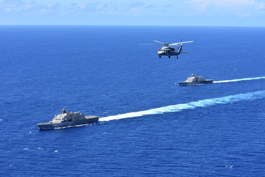 The Freedom-variant littoral combat ships USS Wichita (LCS 13), left, USS Billings (LCS 15), and an MH-60s Sea Hawk helicopter participate in a photo exercise in the Caribbean Sea, Sept. 10.
