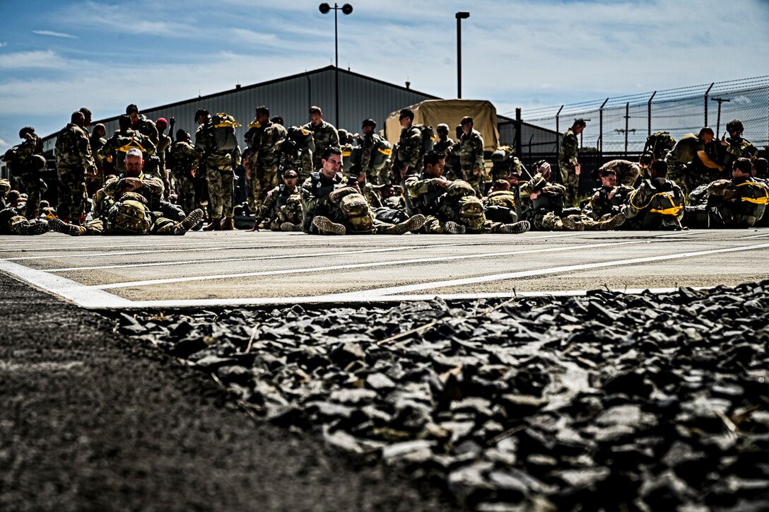 U.S. Army Soldiers assigned to the 404th Civil Affairs Battalion, prepare jump packs for an Airborne operation at Joint Base McGuire-Dix-Lakehurst, N.J. on Sept. 10, 2022. The unit conducted non-tactical airborne operations at the Army Aviation Facility in order to maintain mission readiness and proficiency among their paratroopers with the assistance of two CH-47’s out of Virginia.The Army Aviation Facility was created through a MILCON effort valued at 11.7 million dollars and made possible by the joint effort of ASA Fort Dix and the U.S. Marine Corps Marine Aircraft Group 49. The 2100 square foot building is host to an Army Ramp Management Area which provides a wide range of capabilities for both fixed and rotary wing aircraft such as the C-130, CH-47S, and UH-60S.