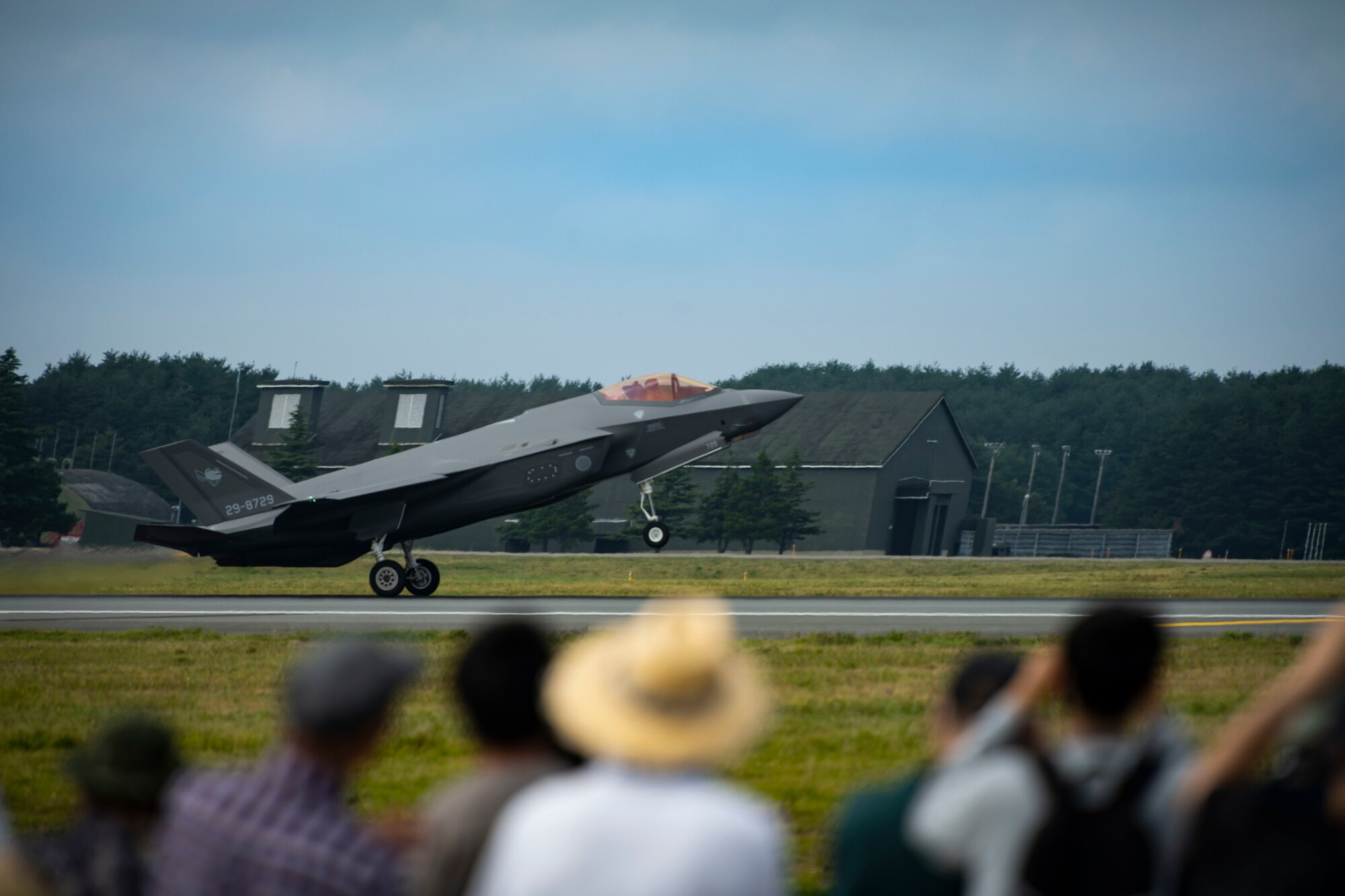 U.S. and Japanese military aircraft are displayed to attendees during an air show.