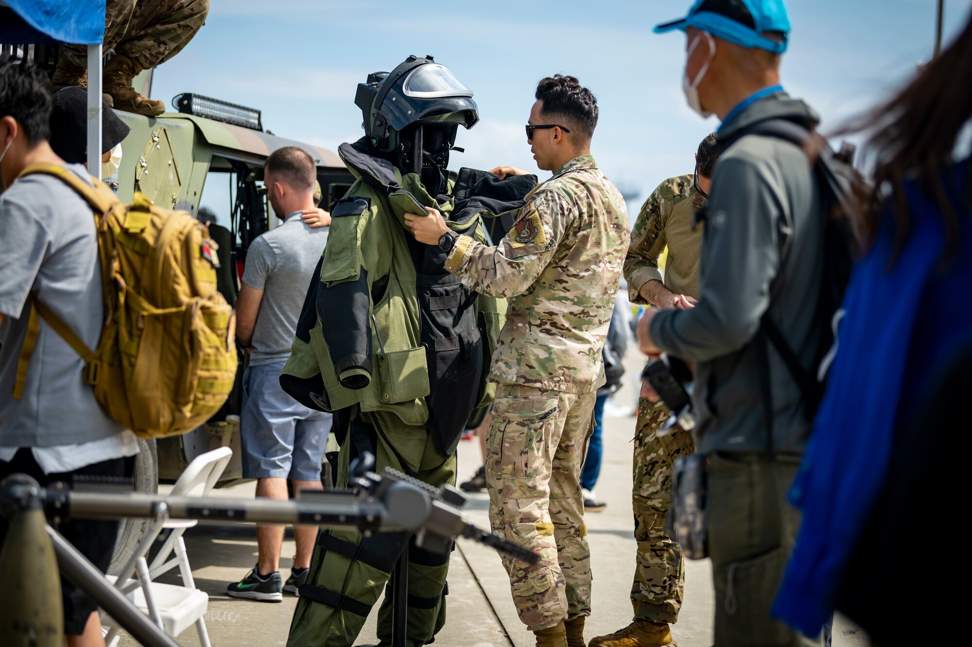 U.S. military members set up an EOD bomb suit on a mannequin.