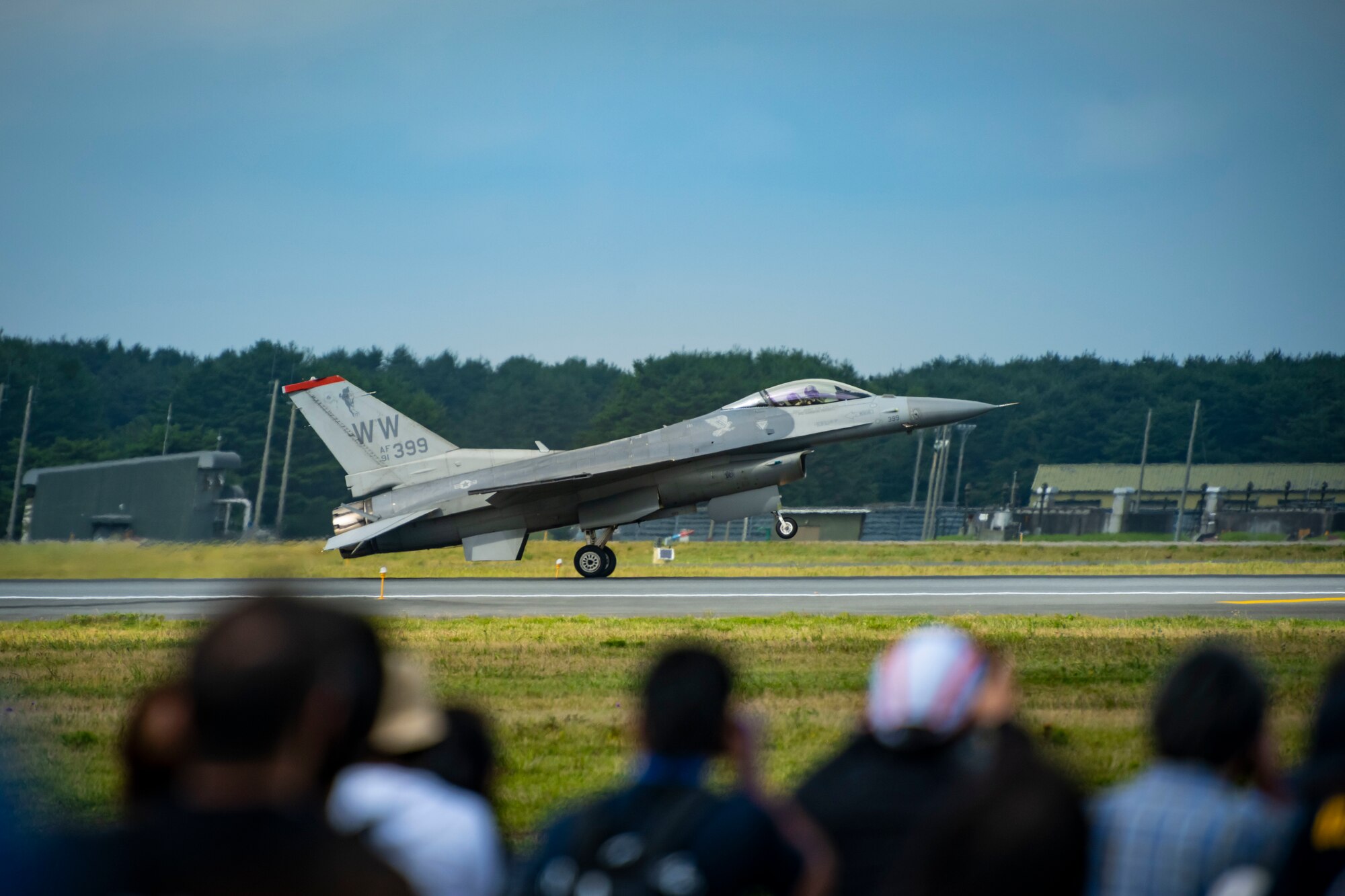 U.S. and Japanese military aircraft are displayed to attendees during an air show.