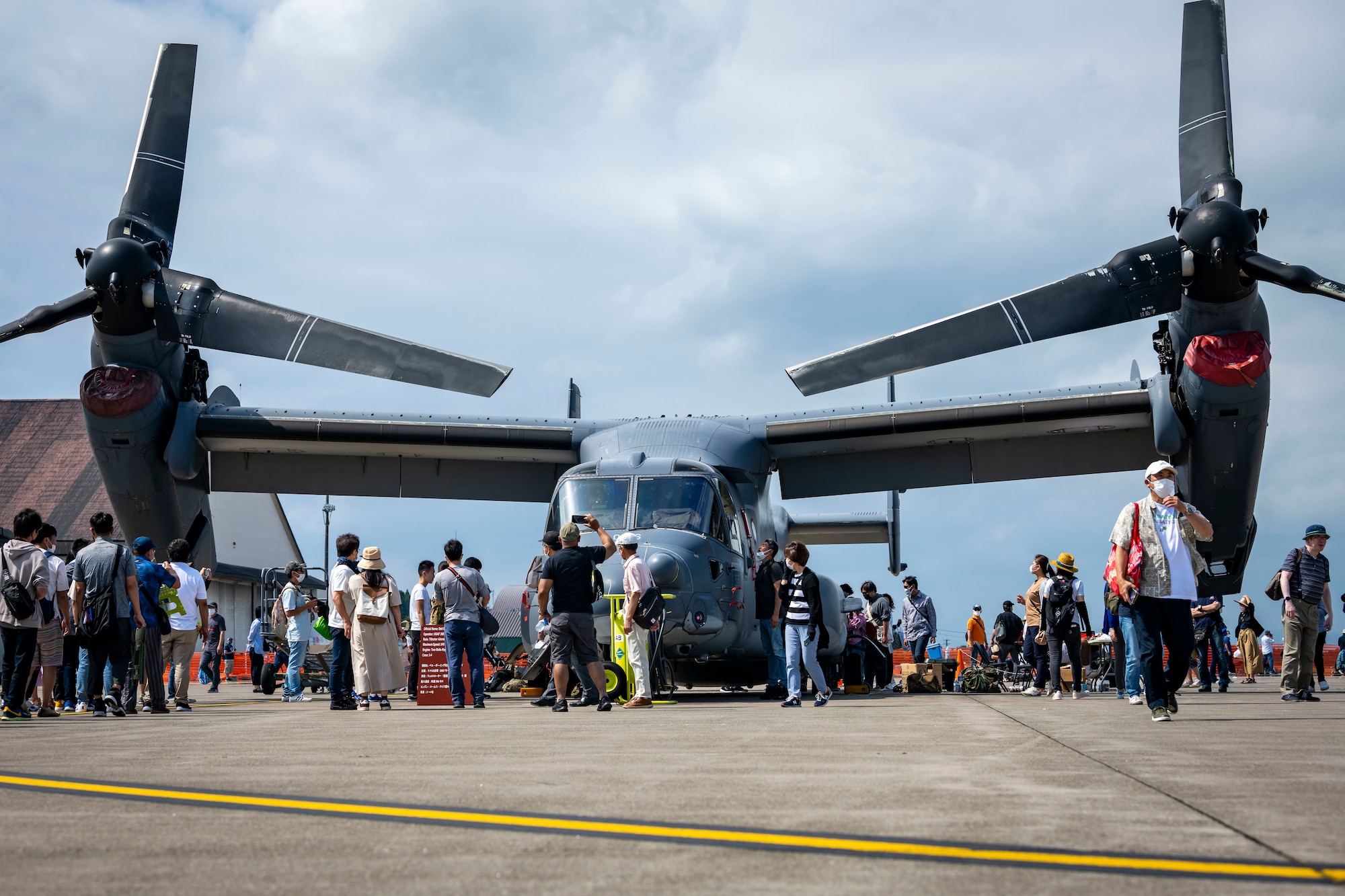 Attendees wait in line leading to an aircraft.