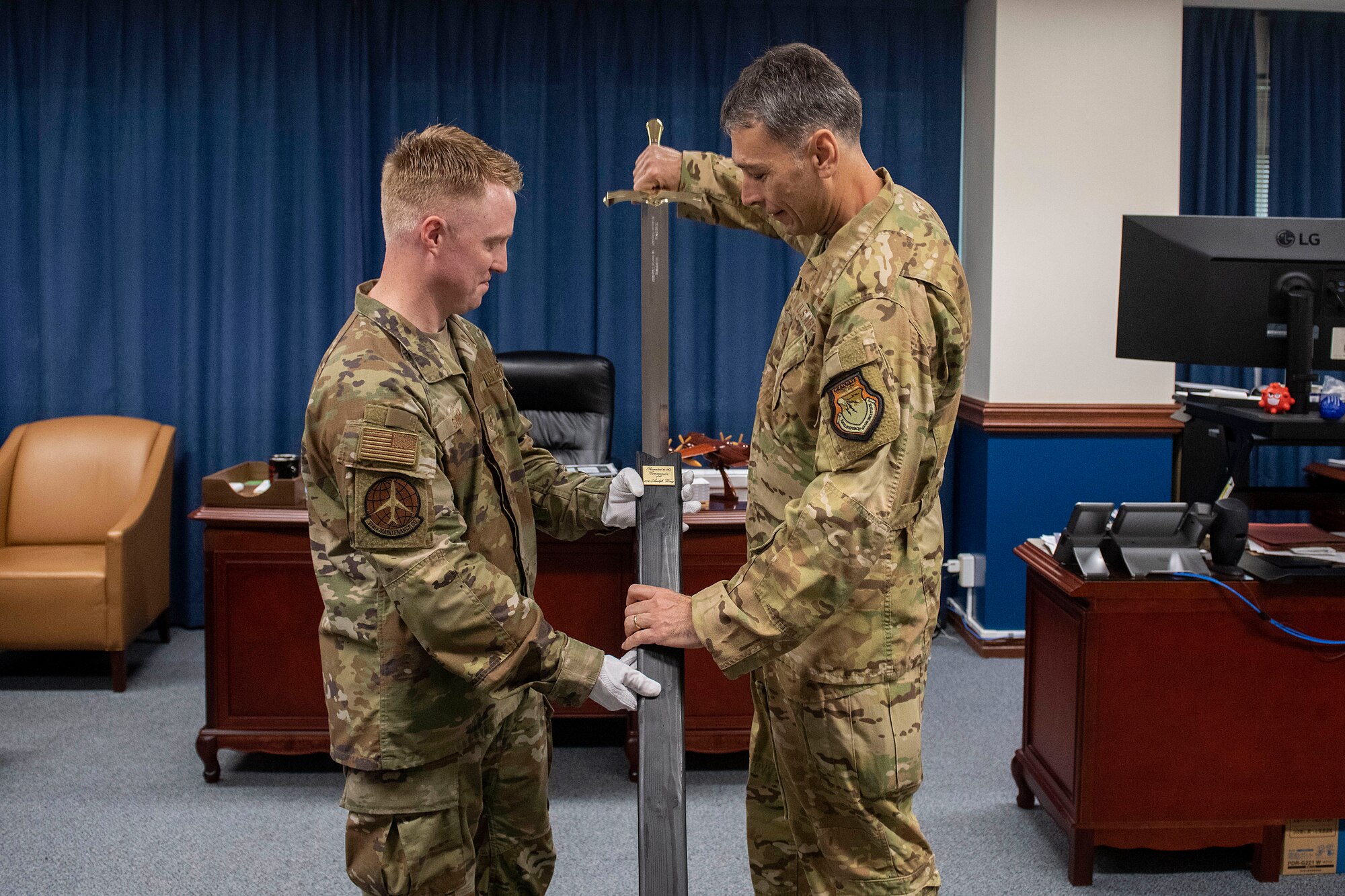 The Wing Commander unsheathes the Wing Ceremonial Sword