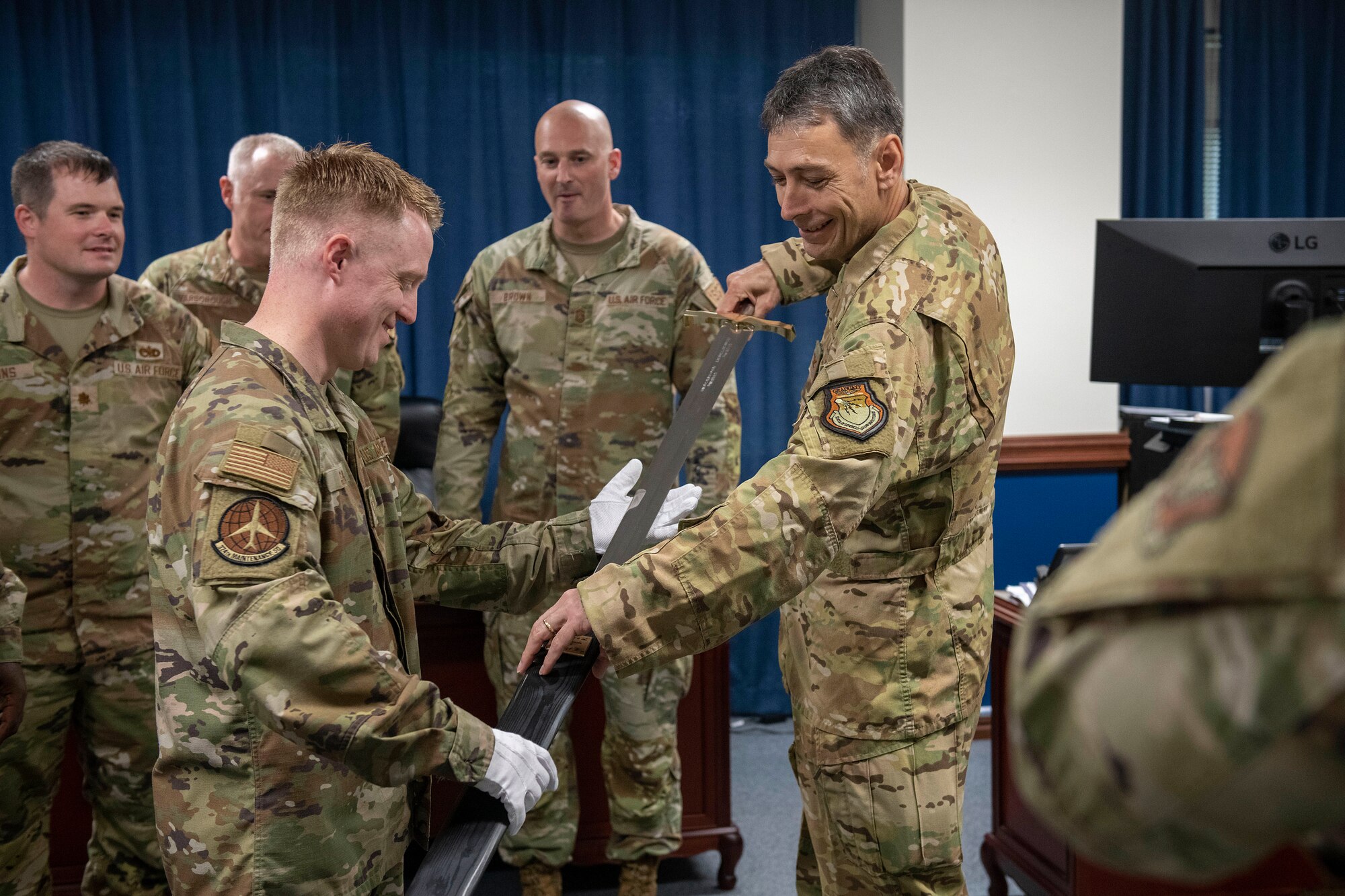 The Wing Commander sheathes the Wing Ceremonial Sword