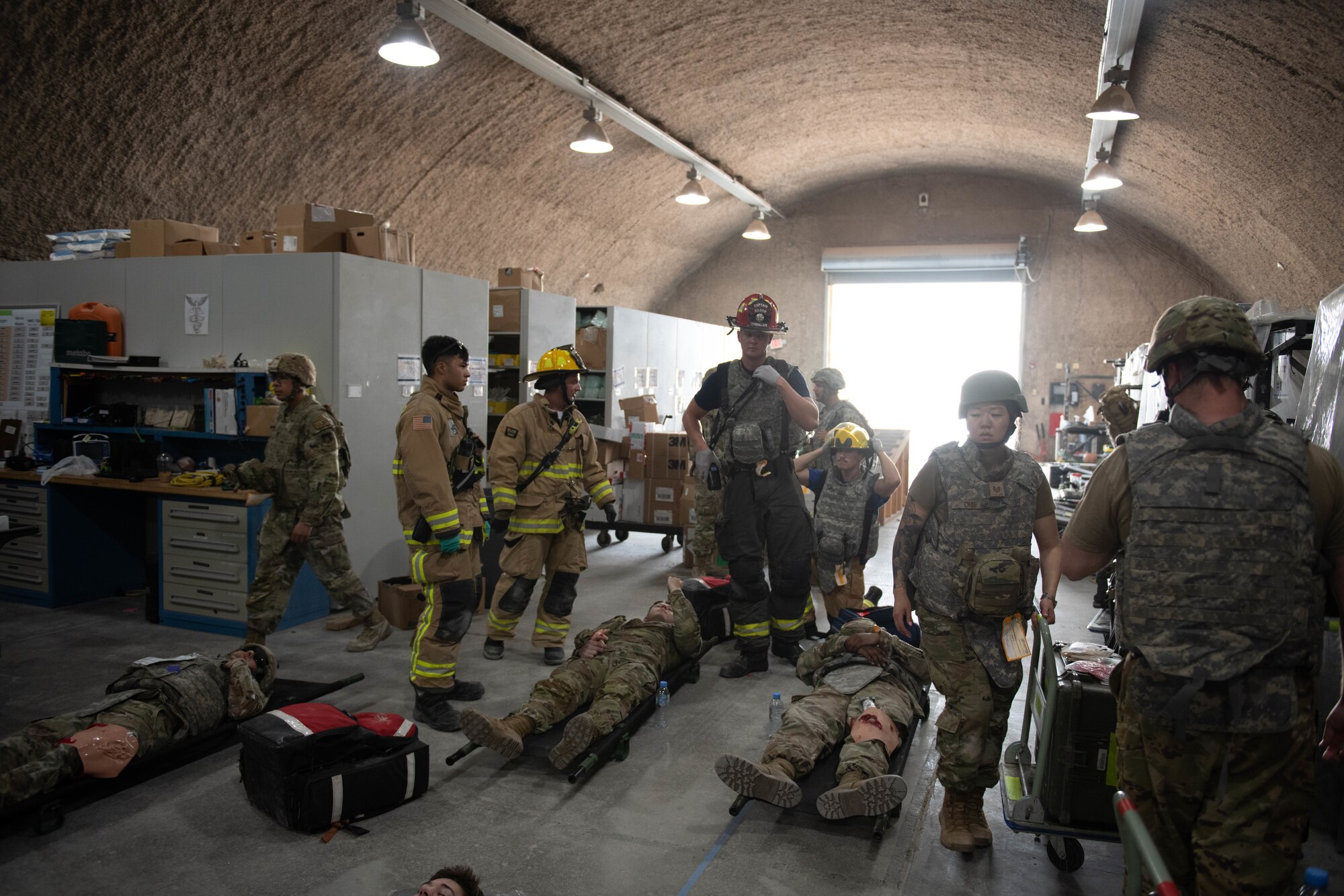 Firefighters from the 379th Expeditionary Civil Engineer Squadron assess simulated mass casualties during Exercise Grand Shield 22-5 on Al Udeid Air Base, Qatar, Sept. 9, 2022. Exercise Grand Shield is a recurring exercise that allows the base to apply their training to different scenarios. (U.S. Air National Guard photo by Airman 1st Class Constantine Bambakidis)