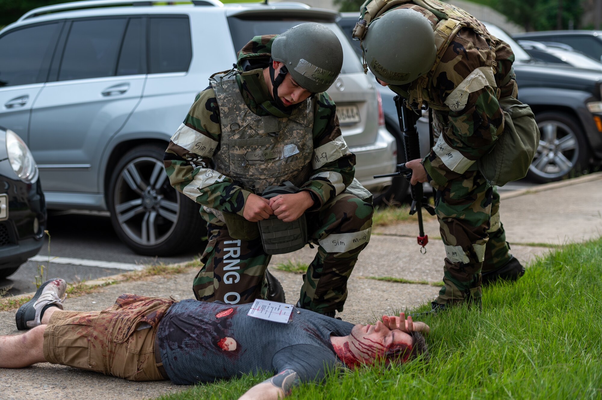 U.S. Air Force Airman Samuel Baldwin and U.S. Air Force Staff Sgt. Ryan Breen, 51st Force Support Squadron shelter management team members, discover and assess a simulated trauma victim during a post-attack reconnaissance sweep during a base-wide training scenario