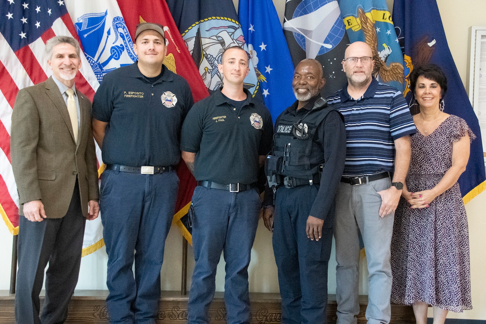 Employees gathered in front of the service flags.