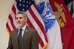 DLA Installation Management Susquehanna Site Director Robert Montefour in front of the service flags.