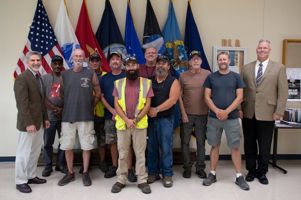 Employees gathered in front of the service flags