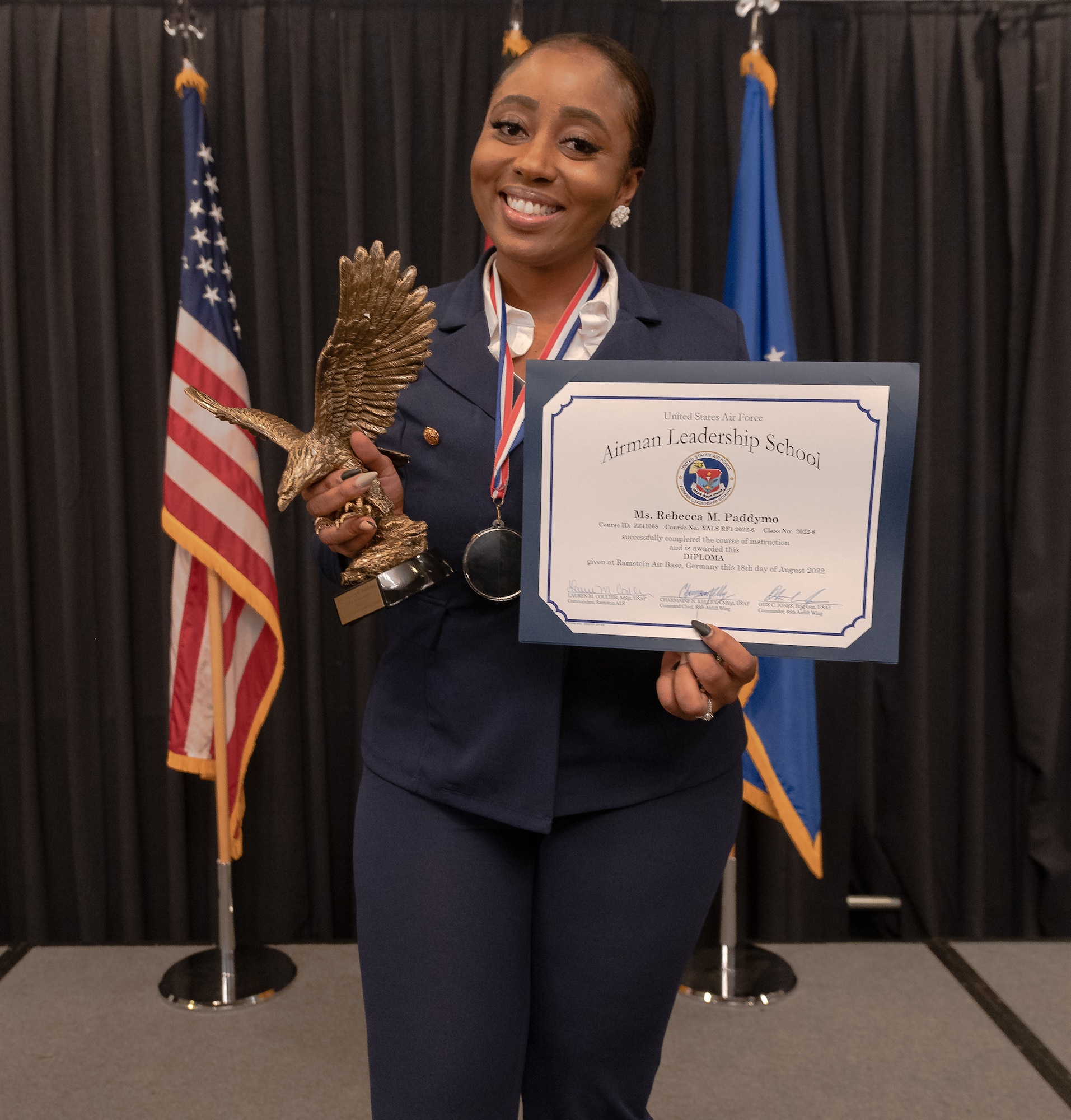 Rebecca Paddymo, 569th U.S. Forces Police Squadron program coordinator, holds the John L. Levitow award and Airman Leadership School diploma at Ramstein Air Base, Germany, Aug. 18, 2022. Paddymo was chosen for the award by her Airman Leadership School peers and for her academic scores.  (U.S. Air Force photo by Airman 1st Class Edgar Grimaldo)