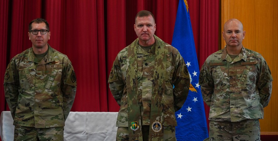 Chaplain Lt. Col. Dallas Little is anointed as Wing Chaplain by Col. Dan Hoadley, 5th Bomb Wing commander, and Global Strike Command Chaplain Col. David Kelley, at Minot Air Force Base, North Dakota, Sept. 13, 2022. The ceremony was the first ever conducted at Minot AFB and one of few ever Air Force wide. (U.S Air Force photo by Senior Airman Zachary Wright)