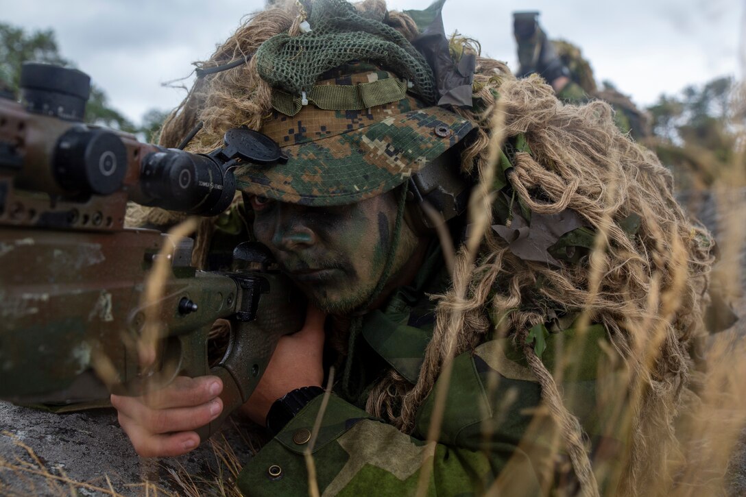 A Swedish Marine with Coastal Ranger Reconnaissance platoon, 2d Swedish Marine Battalion, sights in during live fire exercise during exercise Archipelago Endeavor 2022 (AE22), at Berga Naval Base, Sweden, Sept. 13, 2022. AE22 is an integrated field training exercise that increases operational capability and enhances strategic cooperation between the U.S. Marines and Swedish forces. (U.S. Marine Corps photo by Lance Cpl. Adam Scalin)