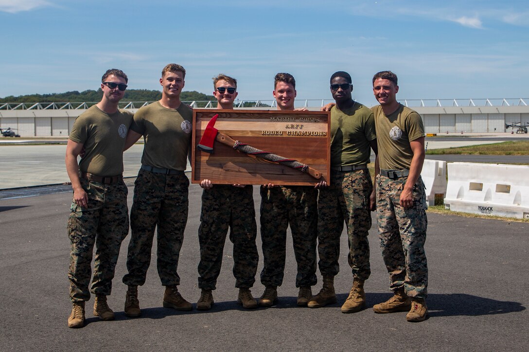 U.S. Marines with team Guns and Hoses are presented with the Aircraft Rescue and Fire Fighter Rodeo Trophy at Marine Corps Air Facility Quantico on Marine Corps Base Quantico, Sep. 2, 2022. The ARFF Rodeo is a competition for Marines to showcase their operational knowledge of firefighting tactics, techniques, and procedures.(U.S. Marine Corps Photo by Lance Cpl. George Nudo)