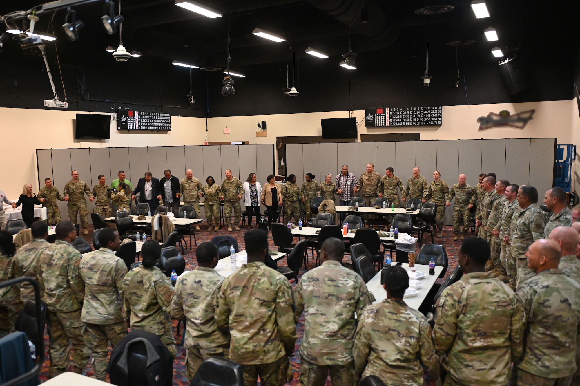 U.S. military personnel and distinguished guests learn a traditional circle dance from Blackfeet Nation citizens at the Glacier Peaks Casino and Resort in Browning, Montana, September 8, 2022. The Blackfeet Nation citizens provided lunch and cultural dance performances to show appreciation for construction of the Blackfeet Nation Senior Center being built in Heart Butte, Montana. (U.S. Air National Guard photo by Airman 1st Class Amy Rangel, 169th Fighter Wing Public Affairs)