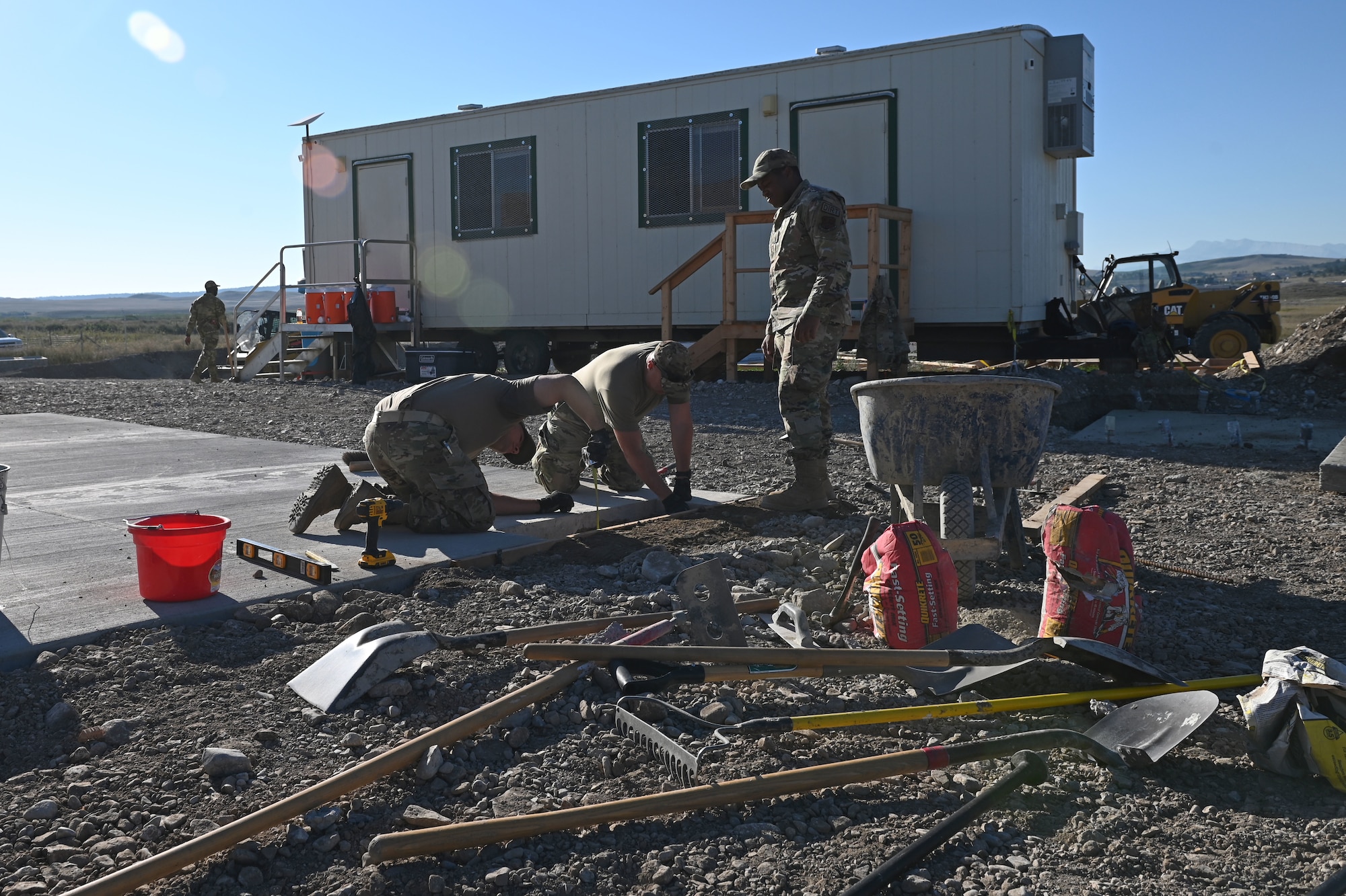 U.S. Air Force Airmen assigned to the 169th Civil Engineer Squadron from the South Carolina Air National Guard make concrete repairs to help build a community center for the Blackfeet Nation Native Americans at Heart Butte, Montana, September 6, 2022. This temporary deployment is part of the 169th Civil Engineer Squadron’s yearly Innovative Readiness Training (IRT) that helps Airmen train in a real-world environment to acquire and maintain their trade skills. (U.S. Air National Guard photo by Airman 1st Class Amy Rangel, 169th Fighter Wing Public Affairs)