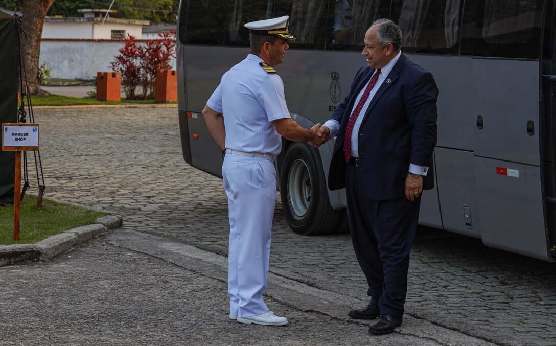 U.S. Secretary of the Navy Carlos Del Toro shakes hands with a Brazilian service member while visiting a training area in Ilha do Governador, Rio de Janeiro during exercise UNITAS LXIII, Sept. 8, 2022. UNITAS is the world’s longest-running annual multinational maritime exercise that focuses on enhancing interoperability among multiple nations and joint forces during littoral and amphibious operations in order to build on existing regional partnerships and create new enduring relationships that promote peace, stability, and prosperity in the U.S. Southern Command’s area of responsibility. (U.S. Marine Corps photo by Lance Cpl. Trystan Taft)
