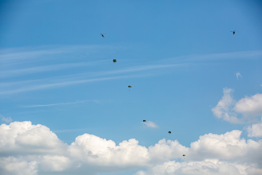 Marines from Brazil, Ecuador, Paraguay, Uruguay, and the United States conduct static line and freefall parachute training from UH-1Y Venom helicopters with Marine Light Attack Helicopter Squadron - 773, 4th Marine Aircraft Wing, Marine Forces Reserve in support of Special Purpose Marine Air-Ground Task Force UNITAS LXIII, at Santa Cruz Air Force Base, Rio de Janeiro, during exercise UNITAS LXIII, Sept. 6, 2022. UNITAS is the world's longest-running annual multinational maritime exercise that focuses on enhancing interoperability among multiple nations and joint forces during littoral and amphibious operations in order to build on existing regional partnerships and create new enduring relationships that promote peace, stability, and prosperity in the U.S. Southern Command’s area of responsibility. (U.S. Marine Corps photo by 1st Lt. Mark Andries)